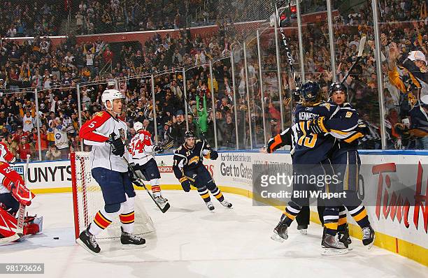 Tim Kennedy of the Buffalo Sabres celebrates his first-period goal with teammate Derek Roy as Bryan Allen of the Florida Panthers skates away on...