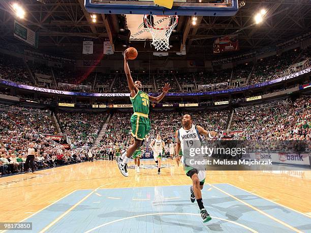 Miles of the Utah Jazz takes the ball to the basket against Wayne Ellington of the Minnesota Timberwolves during the game at the EnergySolutions...