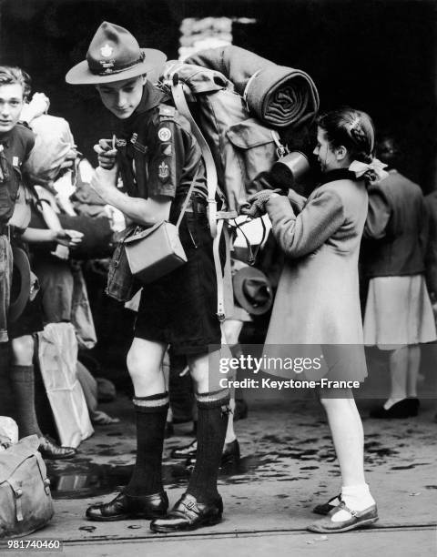 Le scout H Townsend, aidé par sa soeur Anne, part pour le 6ème Jamboree mondial à la gare Victoria à Londres en Angleterre au Royaume-Uni, le 5 août...