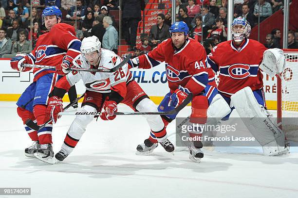 Erik Cole of the Carolina Hurricanes waits for a pass in front of Roman Hamrlik of Montreal Canadiens and teammate Jaroslav Spacek during the NHL...