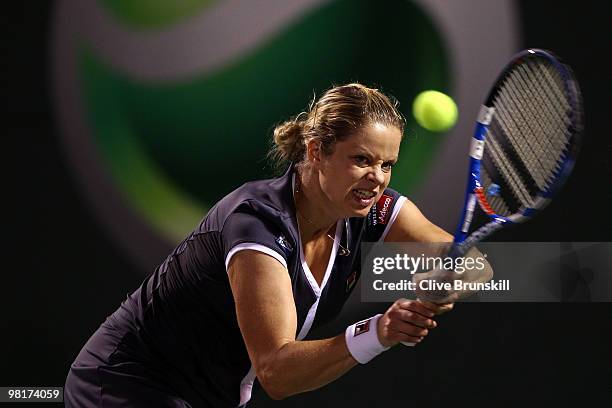 Kim Clijsters of Belgium returns a shot against Samantha Stosur of Australia during day nine of the 2010 Sony Ericsson Open at Crandon Park Tennis...