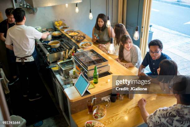 group of friends in a japanese izakaya - jgalione stock pictures, royalty-free photos & images