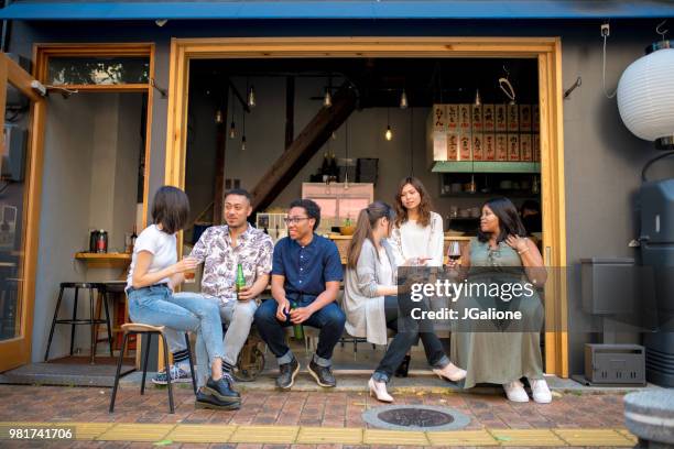 group of friends drinking together at a japanese izakaya - jgalione stock pictures, royalty-free photos & images