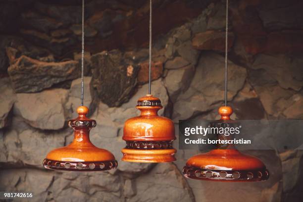 close-up of decoration hanging against stone wall - bortes stockfoto's en -beelden