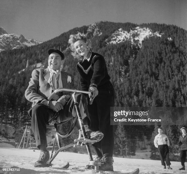 Saint-Granier, assis sur un vélo-ski, et Suzanne Thiollière à Chamonix en France, le 19 février 1947.