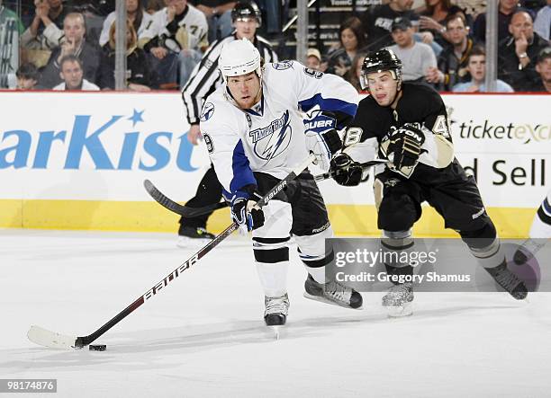 Steve Downie of the Tampa Bay Lightning moves the puck defended by Tyler Kennedy of the Pittsburgh Penguins on March 31, 2010 at Mellon Arena in...