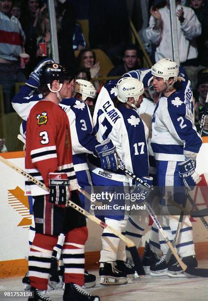 Wendel Clark and Luke Richardson of the Toronto Maple Leafs celebrate a goal against Dave Manson of the Chicago Black Hawks during NHL game action on...