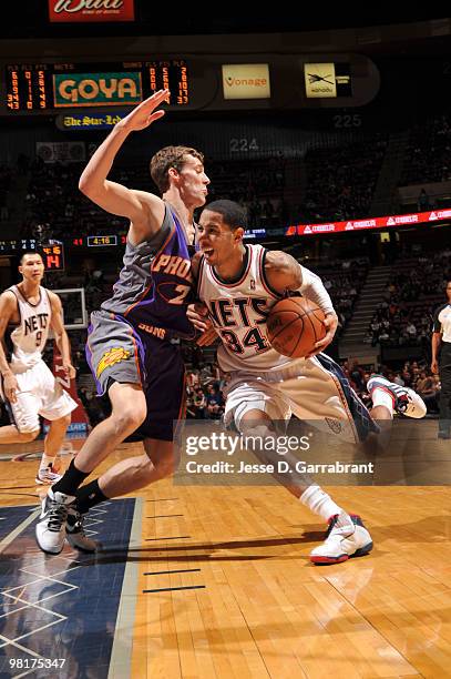 Devin Harris of the New Jersey Nets drives against Goran Dragic of the Phoenix Suns during the game on March 31, 2010 at the Izod Center in East...