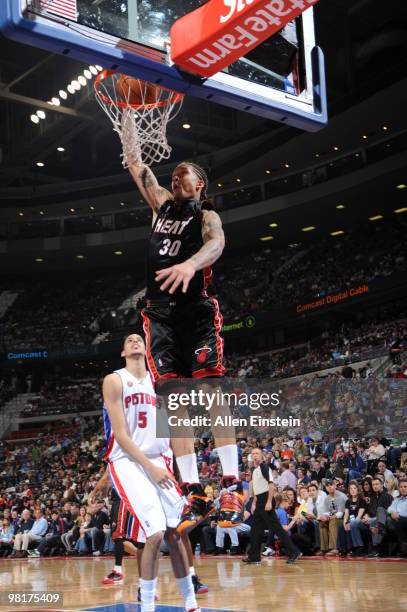 Michael Beasley of the Miami Heat dunks past Austin Daye of the Detroit Pistons in a game at the Palace of Auburn Hills on March 31, 2010 in Auburn...