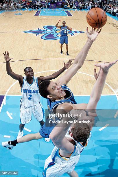 JaVale McGee of the Washington Wizards shoots between Darren Collison and Darius Songaila of the New Orleans Hornetson March 31, 2010 at the New...