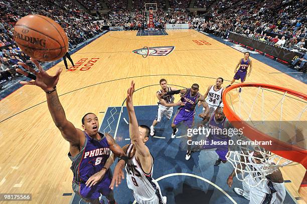 Channing Frye of the Phoenix Suns shoots against Yi Jianlian of the New Jersey Nets during the game on March 31, 2010 at the Izod Center in East...