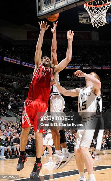 Luis Scola of the Houston Rockets shoots against Matt Bonner of the San Antonio Spurs on March 31, 2010 at the AT&T Center in San Antonio, Texas....