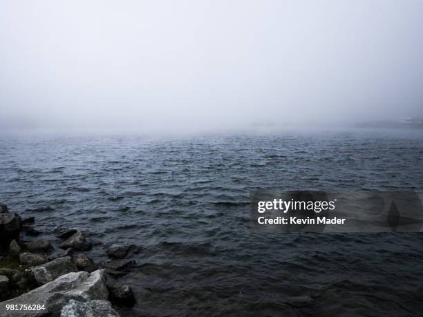 fog over lake at gotthard pass, ticino canton, switzerland - gotthard pass stockfoto's en -beelden