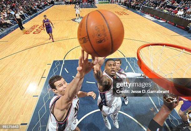 Kris Humphries and Terrence Williams of the New Jersey Nets grab for the rebound against the Phoenix Suns during the game on March 31, 2010 at the...