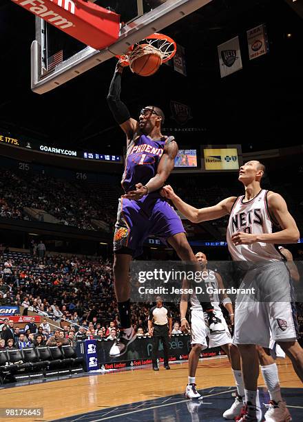 Amar'e Stoudemire of the Phoenix Suns shoots against Yi Jianlian of the New Jersey Nets during the game on March 31, 2010 at the Izod Center in East...