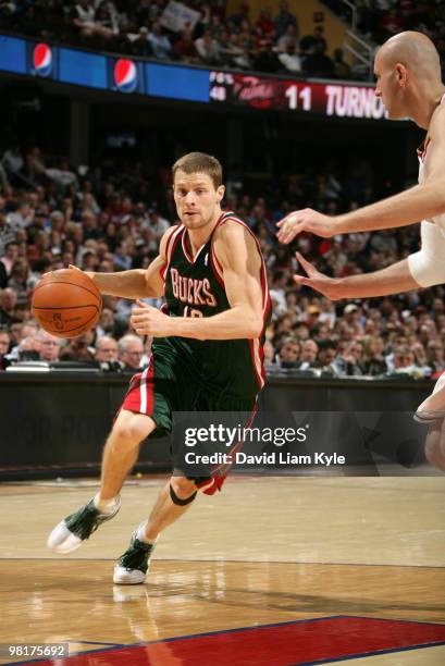 Luke Ridnour of the Milwaukee Bucks drives to the basket against Zydrunas Ilgauskas of the Cleveland Cavaliers on March 31, 2010 at The Quicken Loans...