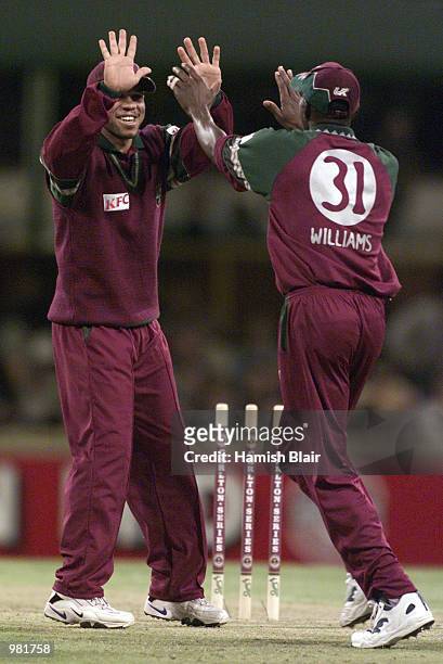 Riccardo Powell of the West Indies celebrates the win with team mate Laurie Williams, during the Carlton Series One Day International between West...