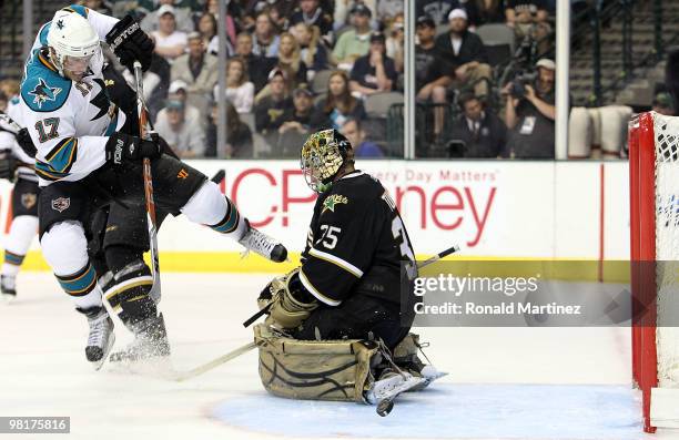 Torrey Mitchell of the San Jose Sharks shoots against Marty Turco of the Dallas Stars at American Airlines Center on March 31, 2010 in Dallas, Texas.