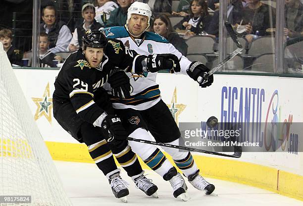 Left wing Steve Ott of the Dallas Stars skates for the puck against Rob Blake of the San Jose Sharks at American Airlines Center on March 31, 2010 in...