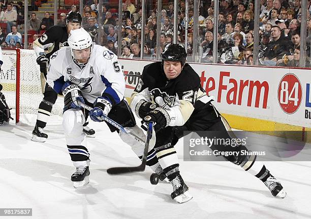Ruslan Fedotenko of the Pittsburgh Penguins battles for the puck against Mattias Ohlund of the Tampa Bay Lightning on March 31, 2010 at Mellon Arena...