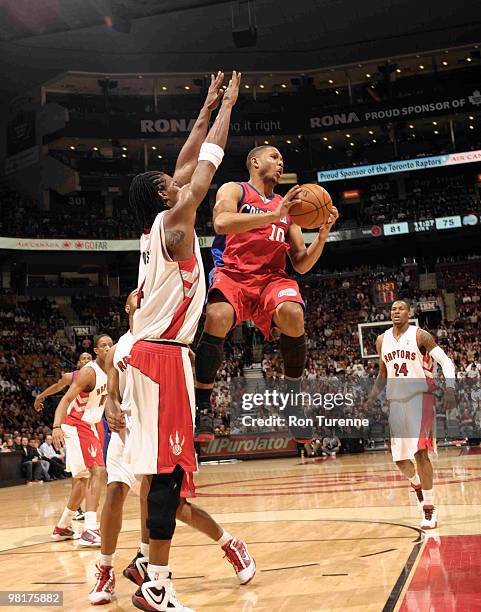 Eric Gordon of the Los Angeles Clippers looks to pass out of the paint in front of Chris Bosh of the Toronto Raptors during a game on March 31, 2010...