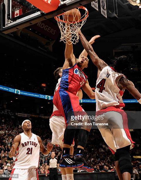 Eric Gordon of the Los Angeles Clippers goes in for the dunk defended by Chris Bosh of the Toronto Raptors during a game on March 31, 2010 at the Air...