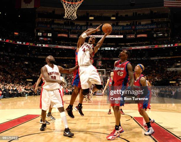 Chris Bosh of the Toronto Raptors drives hard through the lane next to Rasual Butler of the Los Angeles Clippers during a game on March 31, 2010 at...
