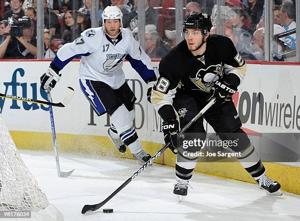 Kris Letang of the Pittsburgh Penguins moves the puck in front of Todd Fedoruk of the Tampa Bay Lightning on March 31, 2010 at Mellon Arena in...