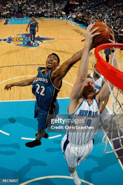 Darius Songaila of the New Orleans Hornets fights for a rebound with James Singleton of the Washington Wizards at New Orleans Arena on March 31, 2010...