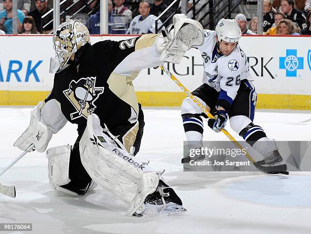 Martin St Louis of the Tampa Bay Lightning takes a shot behind Marc-Andre Fleury of the Pittsburgh Penguins on March 31, 2010 at Mellon Arena in...