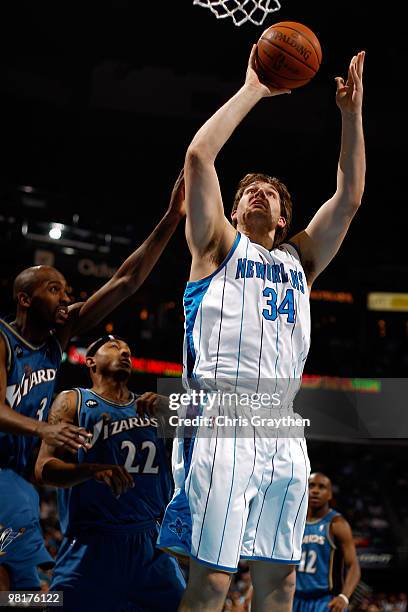 Aaron Gray of the New Orleans Hornets shoots the ball over Quinton Ross of the Washington Wizards at New Orleans Arena on March 31, 2010 in New...