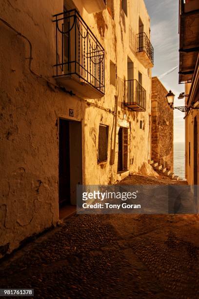 narrow alley in old town at dawn, peniscola, valencian community, spain - costa_del_azahar stock pictures, royalty-free photos & images