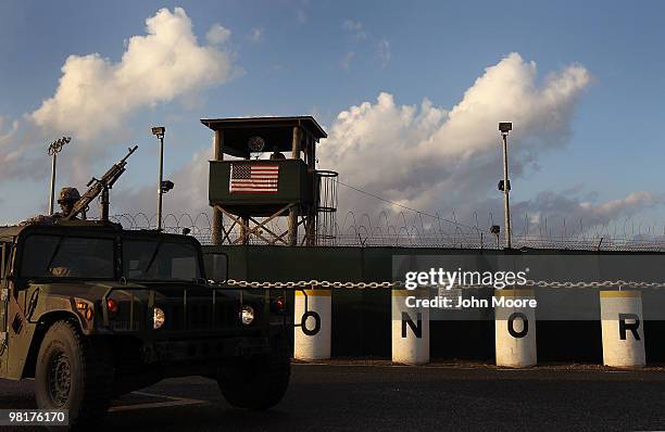 Army patrol passes a guard tower at Camp Delta in the Guantanamo Bay detention center on March 30, 2010 in Guantanamo Bay, Cuba. U.S. President...