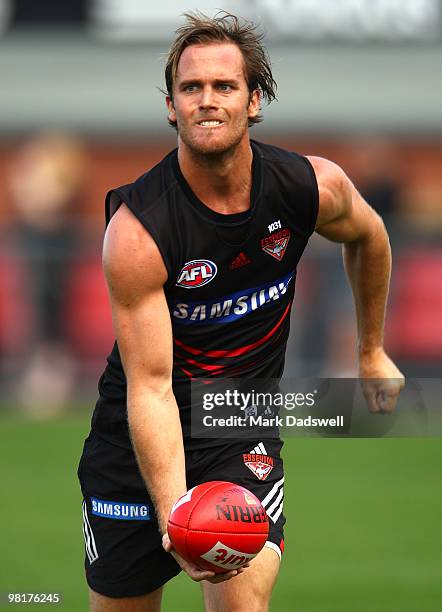 Andrew Welsh of the Bombers handballs to a teammate during an Essendon Bombers AFL training session at Windy Hill on April 1, 2010 in Melbourne,...