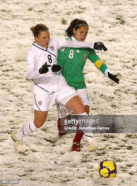 Amy Rodriguez of the United Staes battles against Lupita Worbis of Mexico during the international friendly match between the United States and...