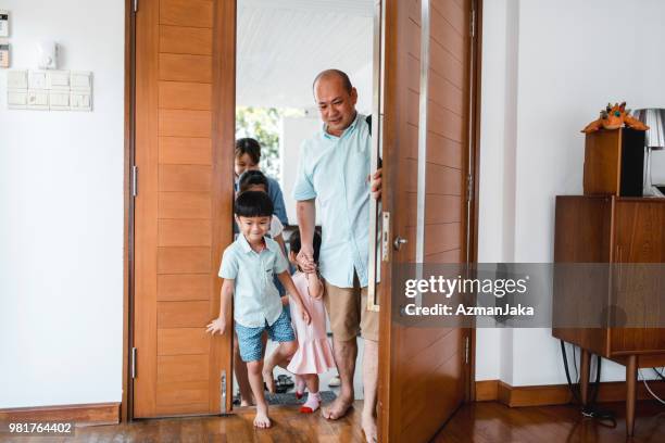 chinese family arriving home - family smiling at front door stock pictures, royalty-free photos & images