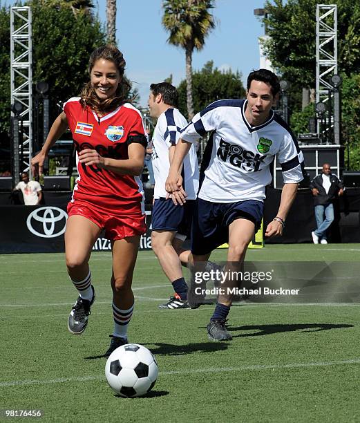 Singer Debi Nova and singer Christian Chavez chase for the ball at MTV Tr3s's "Rock N' Gol" World Cup Kick-Off at the Home Depot Center on March 31,...