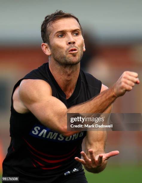 Mark McVeigh of the Bombers handballs to a teammate during an Essendon Bombers AFL training session at Windy Hill on April 1, 2010 in Melbourne,...