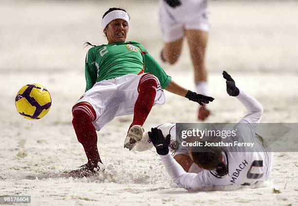 Abby Wambach of the United States battles against Leticia Villalpoado of Mexico during the international friendly match between the United States and...