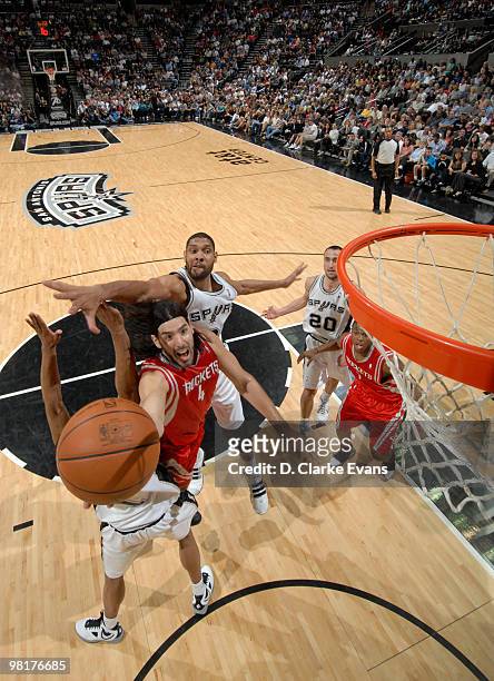 Luis Scola of the Houston Rockets shoots against Tim Duncan of the San Antonio Spurs on March 31, 2010 at the AT&T Center in San Antonio, Texas. NOTE...
