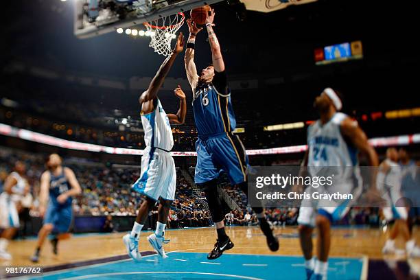 Mike Miller of the Washington Wizards dunks the ball over Emeka Okafor of the New Orleans Hornets at New Orleans Arena on March 31, 2010 in New...