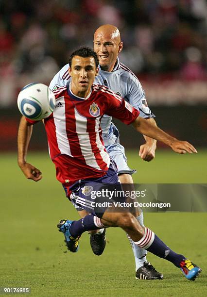 Jonathan Bornstein of Chivas USA turns to the ball in front of Conor Casey of the Colorado Rapids during their MLS match at the Home Depot Center on...