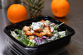 Fresh salad meal packed in a plastic container ready to eat - Healthy takeaway food and eating concept