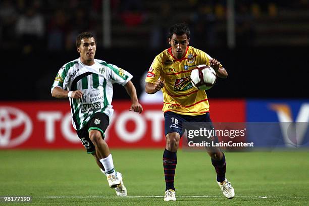 Adrian Aldrete of Mexico's Morelia fights for the ball with Sebastian Fernandez of Argentina's Banfield during a match as part of the 2010...