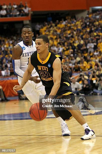 Joe Mazzulla of the West Virginia Mountaineers drives against John Wall of the Kentucky Wildcats during the east regional final of the 2010 NCAA...