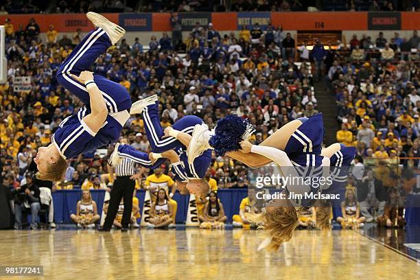 Cheerleaders from the Kentucky Wildcats perform a flip against the West Virginia Mountaineers during the east regional final of the 2010 NCAA men's...