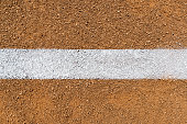 Overhead view of white Foul Line on dirt of baseball diamond