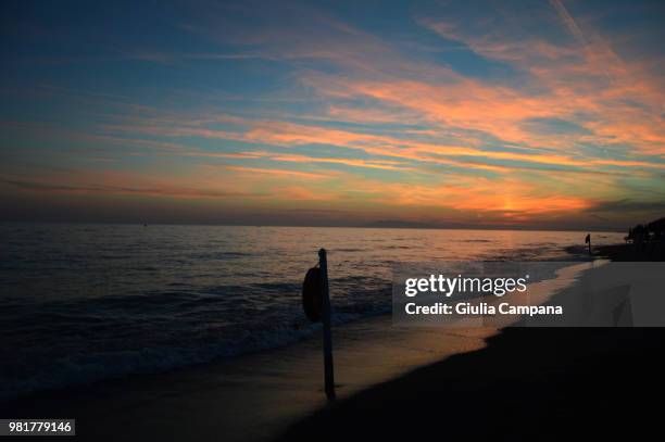 sunset beach - campana stock pictures, royalty-free photos & images