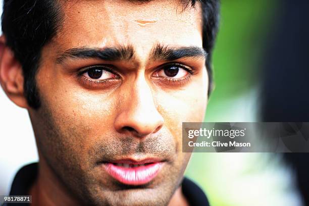 Karun Chandhok of India and Hispania Racing Team walks in the paddock during previews to the Malaysian Formula One Grand Prix at the Sepang Circuit...