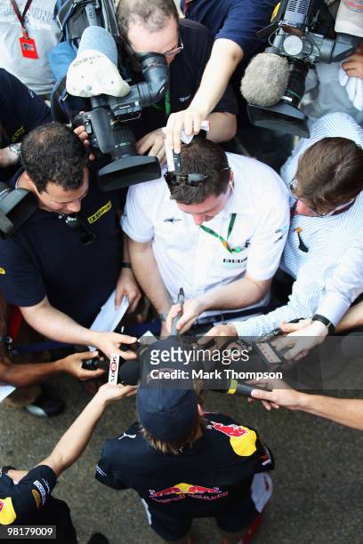 Sebastian Vettel of Germany and Red Bull Racing is interviewed in the paddock during previews to the Malaysian Formula One Grand Prix at the Sepang...